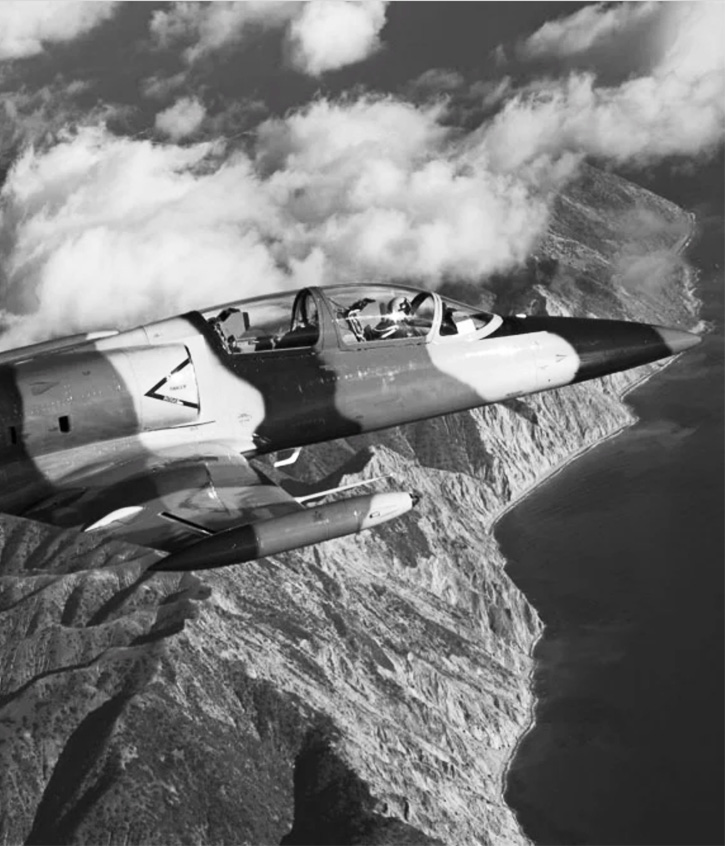 Fighter plane flying above mountains