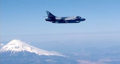 plane flying over a mountain